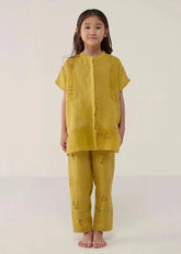 A Model Wearing Yellow Linen Kids Nama Floral Linen Pant- Ochre, curated by Only Ethikal