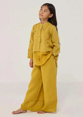 A Model Wearing Yellow Linen Kids Mapa Linen Culottes- Ochre, curated by Only Ethikal