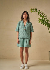 A Model Wearing Green Organic Cotton The Coral organic cotton shacket, curated by Only Ethikal