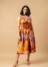 A Model Wearing Orange Organic Cotton Midsummer Smocked Dress, curated by Only Ethikal