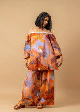 A Model Wearing Orange Organic Cotton Firefly Flicker Printed Pants, curated by Only Ethikal