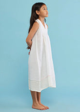 A Model Wearing White Linen Kids Ita Pleated Linen Dress- White, curated by Only Ethikal