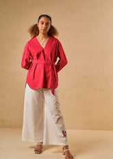A Model Wearing Red Organic Cotton Coral Sunset organic cotton shirt, curated by Only Ethikal