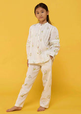 A Model Wearing White Linen Kids Nama Floral Linen Pant- White, curated by Only Ethikal