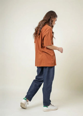 A Model Wearing Orange Organic Cotton Rust Alter Culture T-Shirt, curated by Only Ethikal