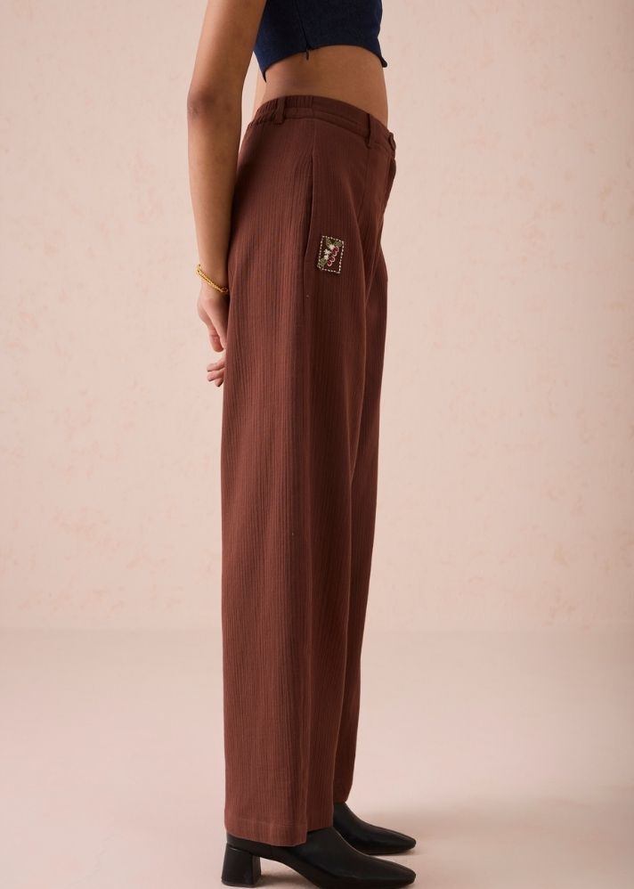 A Model Wearing Brown Organic Cotton Under The Sun Organic Cotton Trousers, curated by Only Ethikal