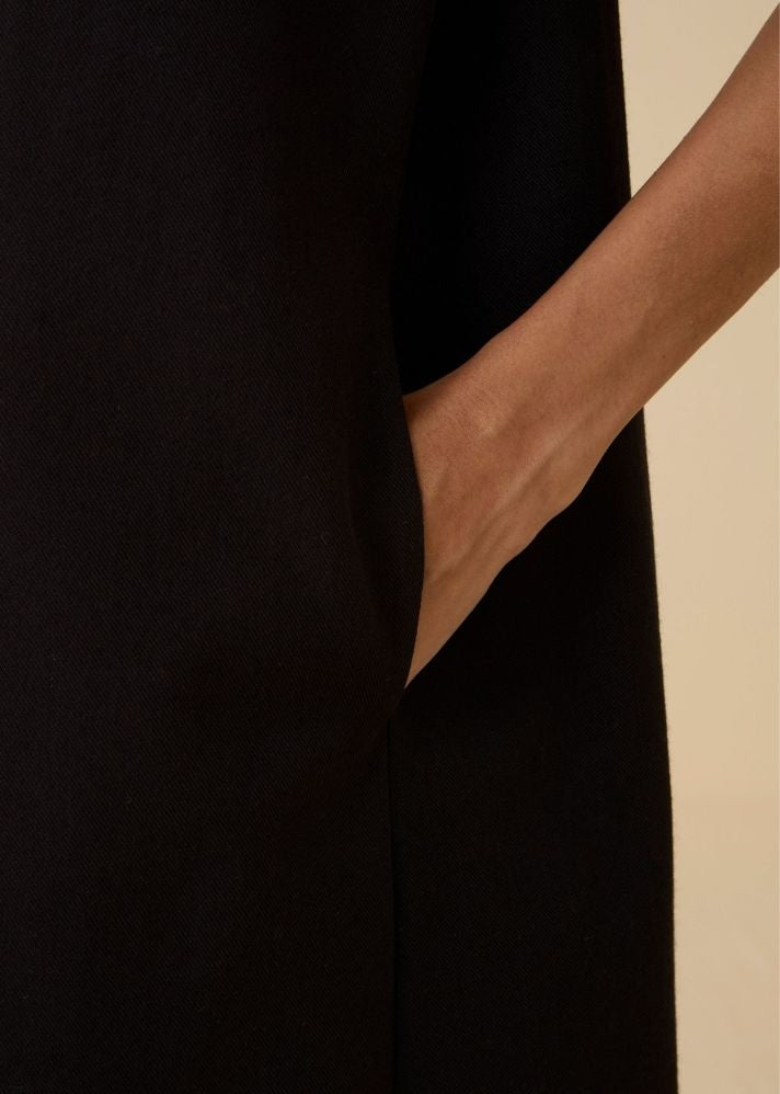 A Model Wearing Black Wool Cotton Ehan Black Hand Applique Dress , curated by Only Ethikal