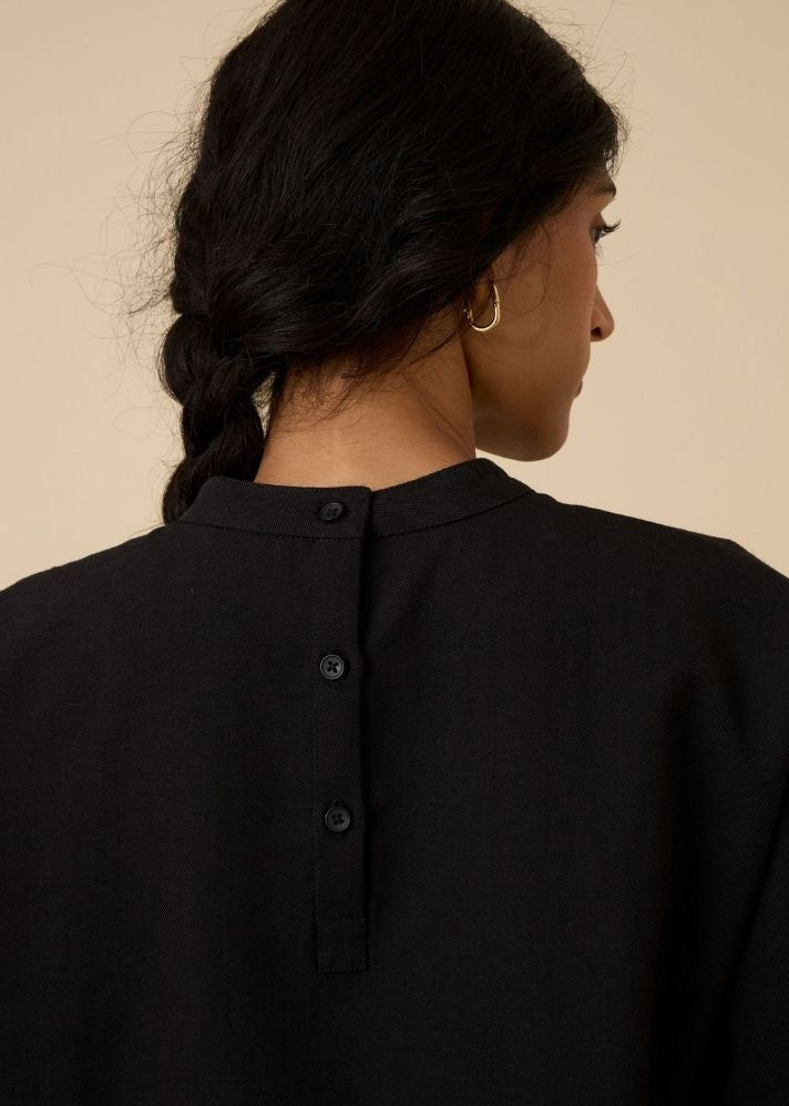 A Model Wearing Black Wool Cotton Ehan Black Hand Applique Dress , curated by Only Ethikal