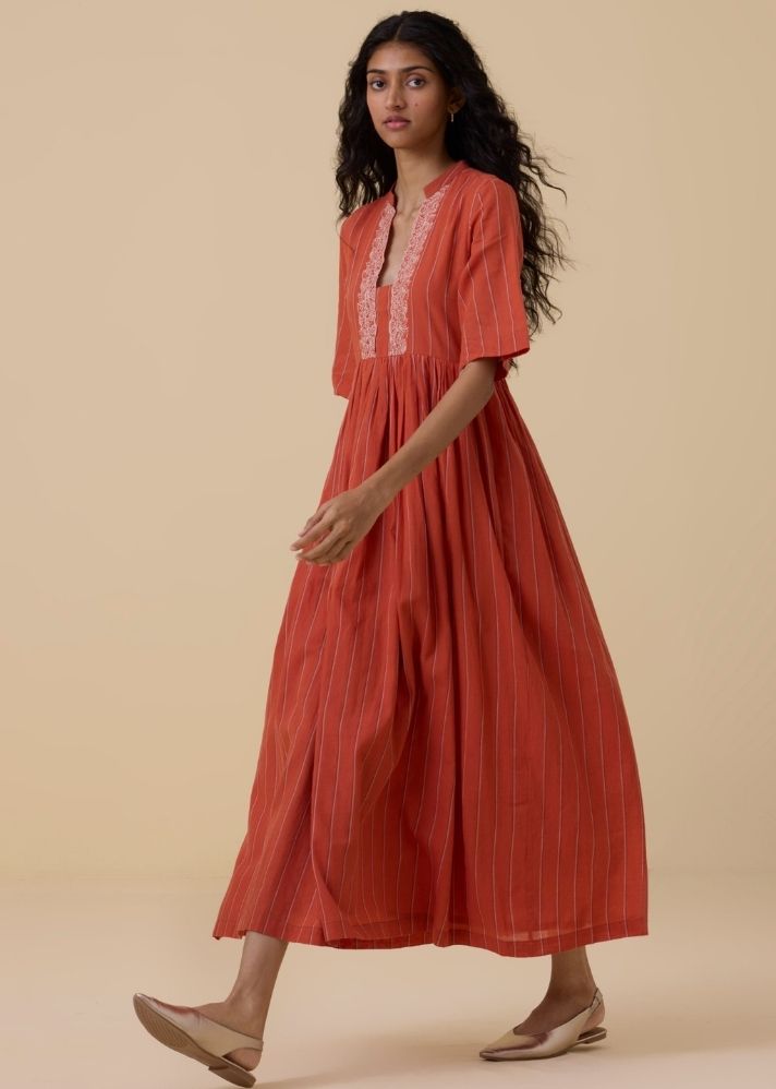 A Model Wearing Orange Handwoven Cotton Sabah Orange Cotton Striped Midi Dress , curated by Only Ethikal