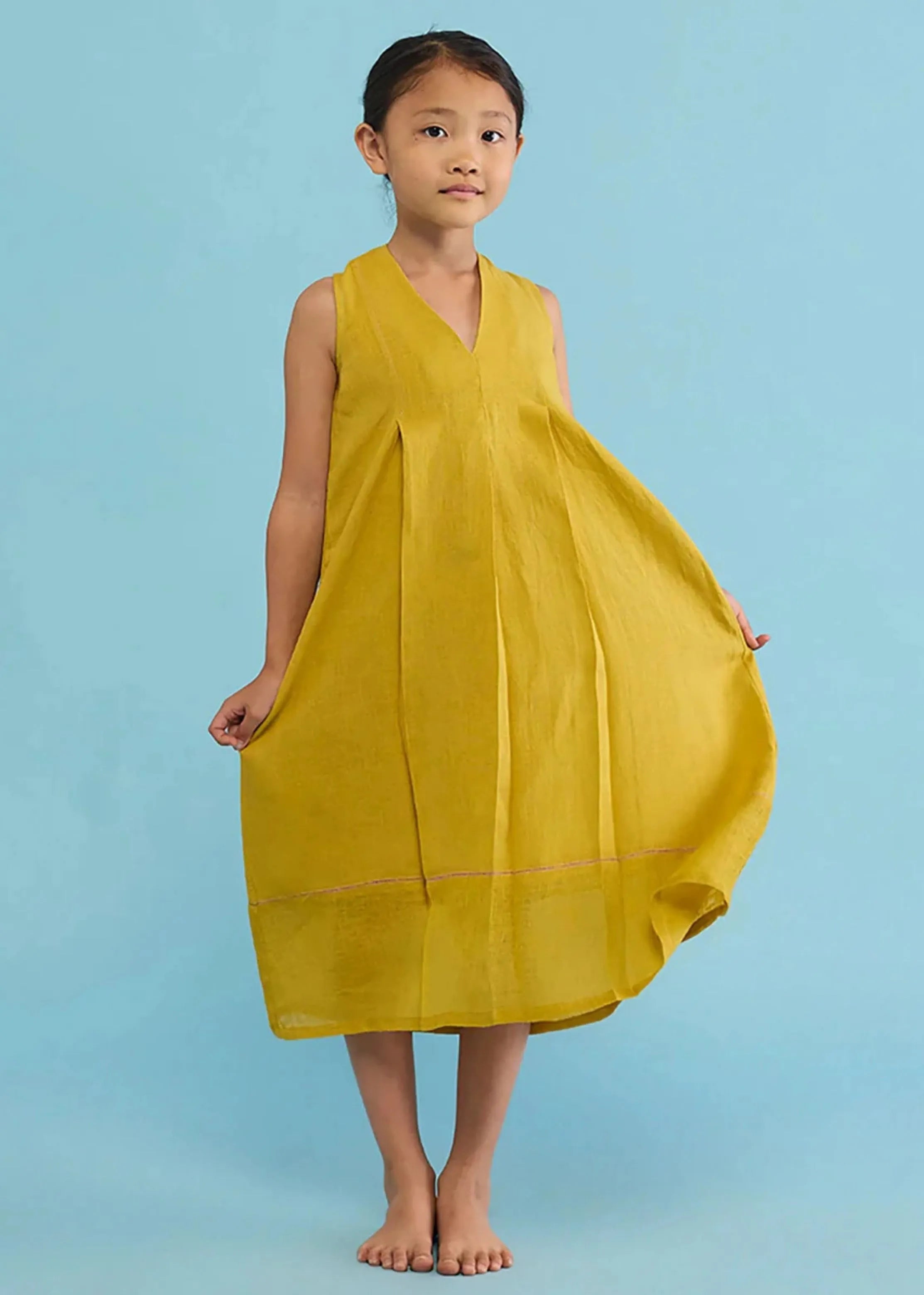 A Model Wearing Yellow Linen Kids Ita Pleated Linen Dress- Ochre, curated by Only Ethikal