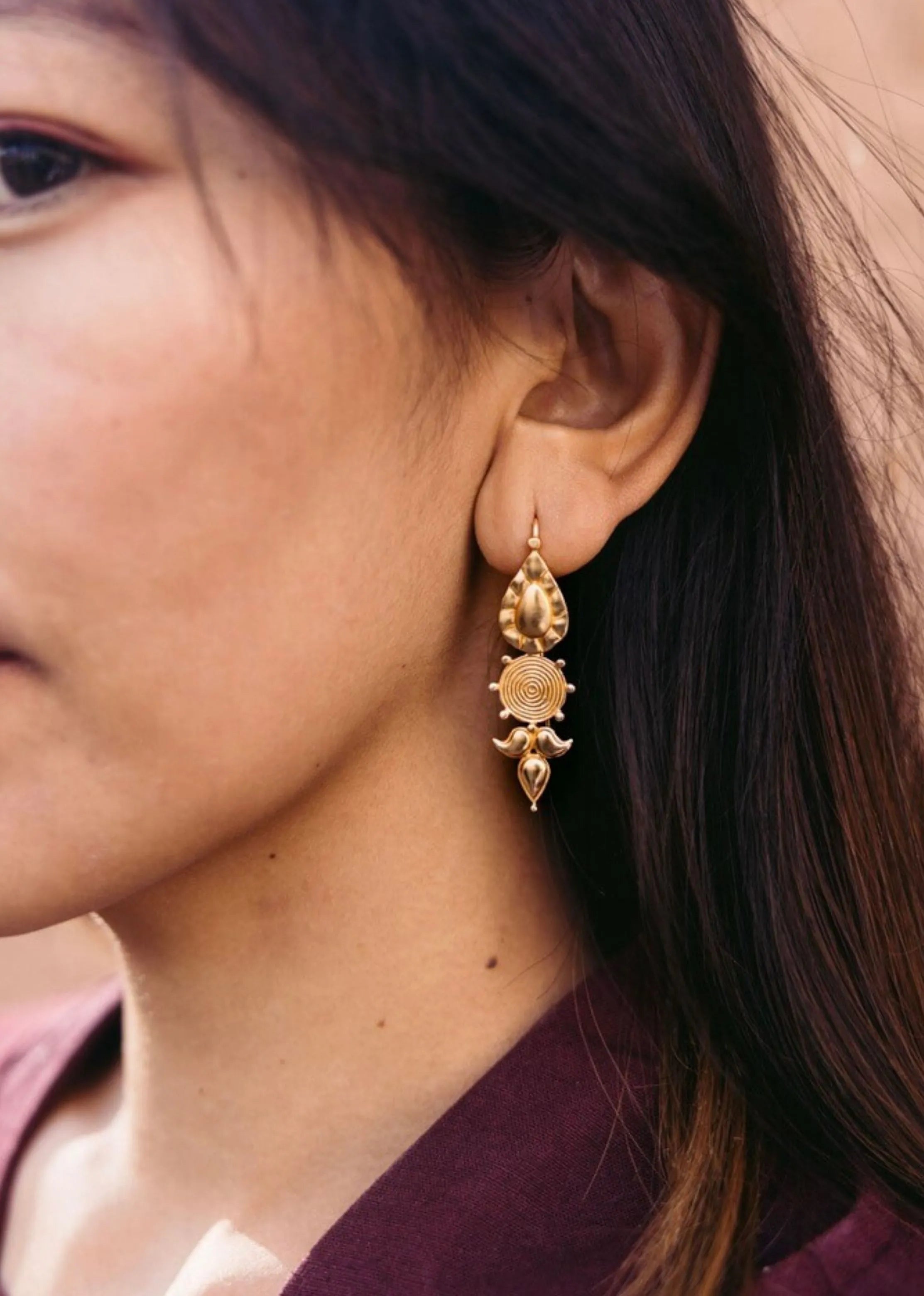 A Model Wearing Gold 18k Gold plated over brass Gold Na-Gyen Akor Earrings, curated by Only Ethikal