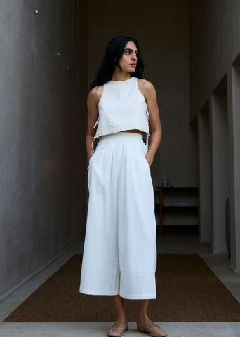A Model Wearing White Cotton Khadi Woodstock Milk Pleated Pants, curated by Only Ethikal