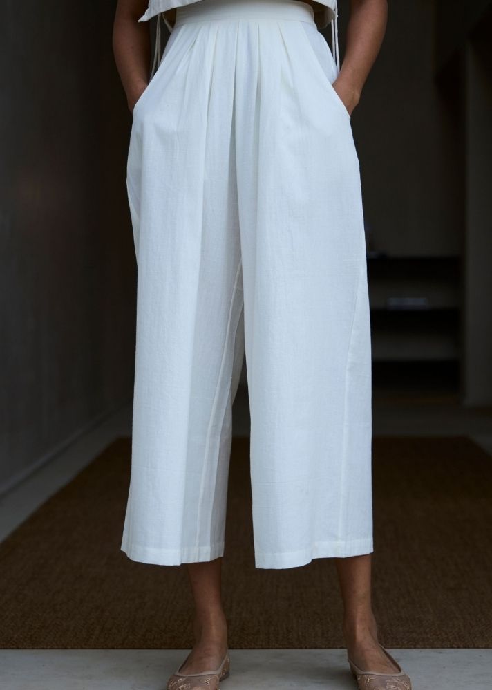 A Model Wearing White Cotton Khadi Woodstock Milk Pleated Pants, curated by Only Ethikal