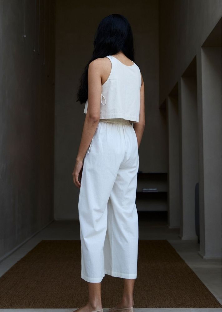 A Model Wearing White Cotton Khadi Woodstock Milk Pleated Pants, curated by Only Ethikal