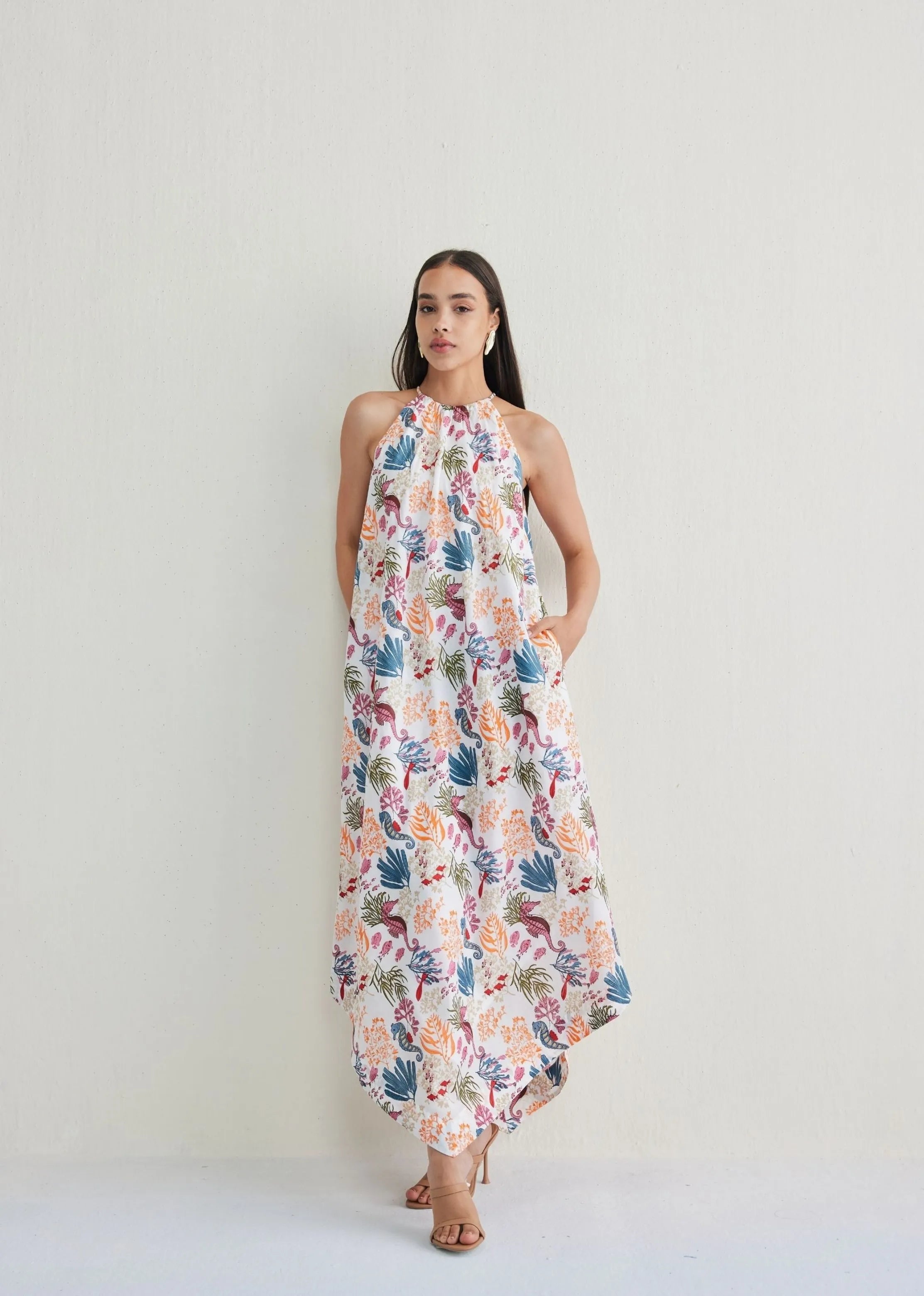 A Model Wearing White Lyocell Deep Sea Lyocell Halter Maxi Dress, curated by Only Ethikal