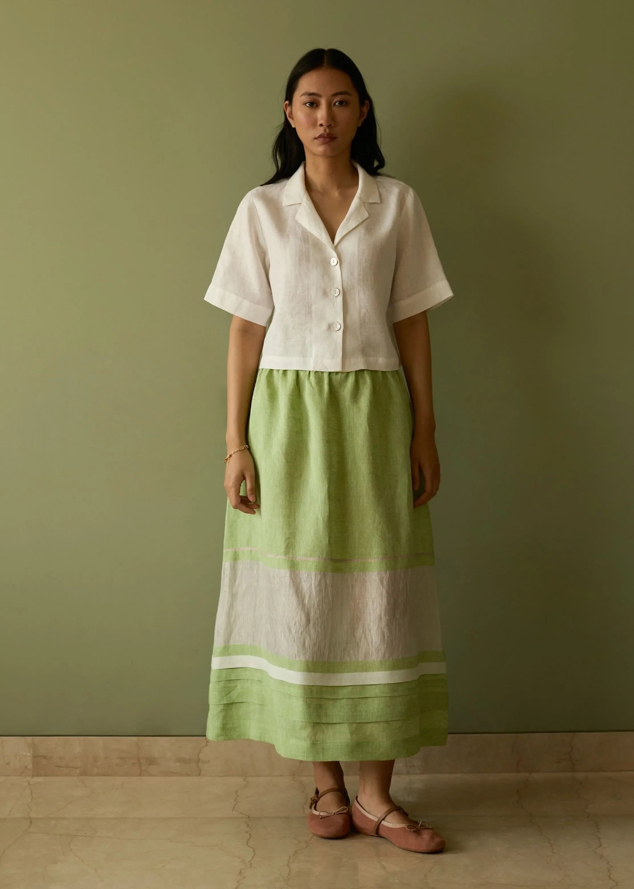 A Model Wearing Green Linen Ora Pleated Border Linen Skirt- Meadow, curated by Only Ethikal